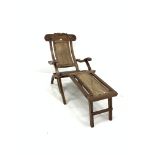 Early 20th century teak folding steamer chair, leaf scroll carved cresting rail, cane back and foot