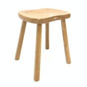 'Mouseman' Yorkshire oak four leg stool, with adzed saddle seat raised on octagonal tapered supports