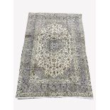 Persian ivory ground rug, central star motif enclosed by interlaced foliate, with multi line border,