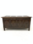 17th century oak coffer, four panelled lid revealing plain interior, scroll carved frieze and lozeng