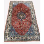 Persian Saroug ground rug, floral medallion on busy red field, floral decoration to border, 220cm x