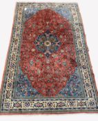 Persian Saroug ground rug, floral medallion on busy red field, floral decoration to border, 220cm x