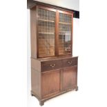 George III mahogany secretaire bookcase, glazed doors with brass grill enclosing three adjustable sh