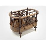 Victorian figured walnut Canterbury magazine rack, with two divisions raised on turned spindle galle