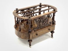 Victorian figured walnut Canterbury magazine rack, with two divisions raised on turned spindle galle