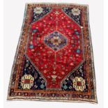 Persian Qashqai ground rug, with lozenge medallion on red field decorated with stylised animals and
