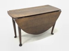 Georgian oak drop leaf gateleg table, with oval top over drawer to one end and shaped apron, raised