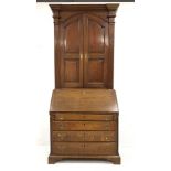 Georgian oak bureau bookcase, two arched fielded panelled doors enclosing four adjustable shelves, e