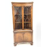 Georgian style mahogany concave fronted corner cabinet, with dentil cornice over astragal glazed doo