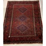 Persian hand knotted ground carpet, with pole medallion on red field, enclosed by multi line border,