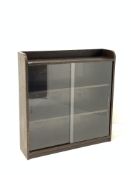 Phoenix Galleries 'Criterion' stained oak bookcase, with sliding glass doors enclosing two shelves,