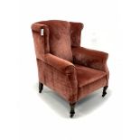 Georgian design wingback armchair, upholstered in velvet, raised on cabriole supports and castors, W