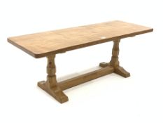 'Mouseman' Yorkshire oak oblong occasional table, with adzed top raised on octagonal turned supports