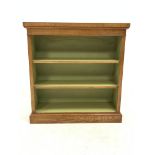 Figured oak open bookcase, cross banded and inlaid top over two adjustable shelves, plinth base, W96