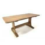 'Acornman' Yorkshire oak dining table, with adzed top raised on shaped and adzed panel end supports