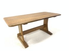 'Acornman' Yorkshire oak dining table, with adzed top raised on shaped and adzed panel end supports