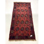 Eastern red ground rug, with repeating gul motif on red field, 100m x 212cm