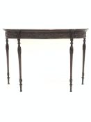 Rosewood serpentine console table, frieze intricately carved with interlaced foliate and acanthus le