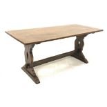 Distressed oak refectory dining table, with rectangular top raised on shaped and pierced panel end s