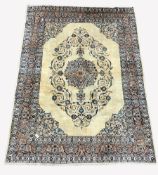 Persian Kashan ground rug, floral medallion enclosed by interlaced trailing foliate on ivory field,