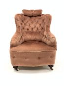 Victorian sprung back armchair, upholstered in buttoned pink velvet, raised on turned mahogany suppo