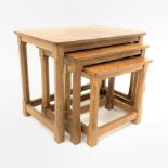 'Mouseman' Yorkshire oak nest of three tables, each with adzed tops, raised on octagonal turned supp