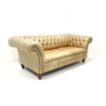 Late 20th century three seat Chesterfield sofa, upholstered in deep buttoned tan leather, raised on