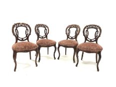 Set of four Victorian mahogany side chairs, with floral and scroll carved open back over upholstered