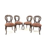 Set of four Victorian mahogany side chairs, with floral and scroll carved open back over upholstered