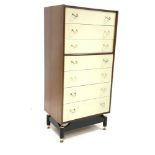 G-Plan tall chest, fitted with seven drawers with brass handles, raised on ebonised base and brass s