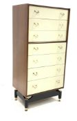 G-Plan tall chest, fitted with seven drawers with brass handles, raised on ebonised base and brass s