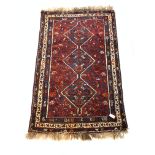 Eastern rug, with pole medallion on red field, enclosed by multi line border, 200cm x 122cm