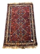 Eastern rug, with pole medallion on red field, enclosed by multi line border, 200cm x 122cm