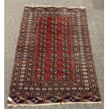 Persian Afghan design Bokhara ground rug, with repeating gul motif on red field, enclosed by multi l