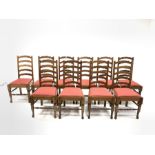 Set of twelve oak waved ladder back dining chairs with drop in upholstered seat pads and turned fron