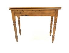 Victorian design pine tea table, the fold over revolving top raised on turned supports, W102cm