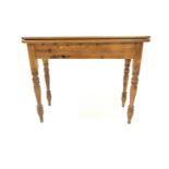 Victorian design pine tea table, the fold over revolving top raised on turned supports, W102cm