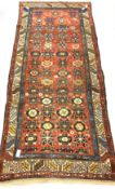 Caucasian runner rug, with stylised floral design on red field, enclosed by guarded border, 270cm x