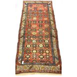 Caucasian runner rug, with stylised floral design on red field, enclosed by guarded border, 270cm x