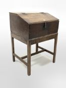 18th century oak bible box, sloped front lifting to reveal interior fitted with two cubby holes, and