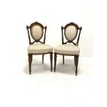 Pair of Victorian walnut upholstered hall chairs, floral carved cresting rail and fluted back suppor