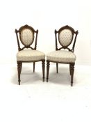 Pair of Victorian walnut upholstered hall chairs, floral carved cresting rail and fluted back suppor