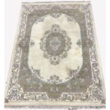 Large Chinese washed woollen ground carpet, with floral medallion on ivory field, enclosed by floral