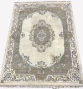 Large Chinese washed woollen ground carpet, with floral medallion on ivory field, enclosed by floral