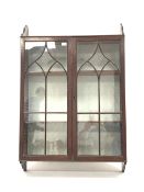 19th century mahogany wall hanging display cabinet, with Gothic arched tracery glazed doors enclosin