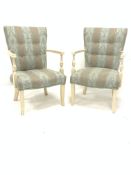 Pair of French style painted hardwood open armchairs, upholstered in striped floral fabric, raised o