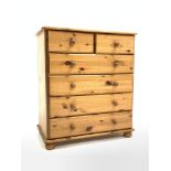 Modern polished pine chest fitted with two short and four long drawers, raised on compressed bun sup