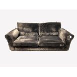 Contemporary three seat sofa, upholstered in brown crushed velvet, with squab cushions, raised on bl