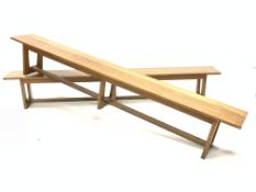 Large pair of 20th century oak benches, each raised on three supports united by stretchers, W290cm,