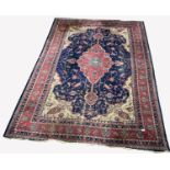 Large Persian design blue ground carpet, with lozenge medallion on blue field enclosed by stylised g